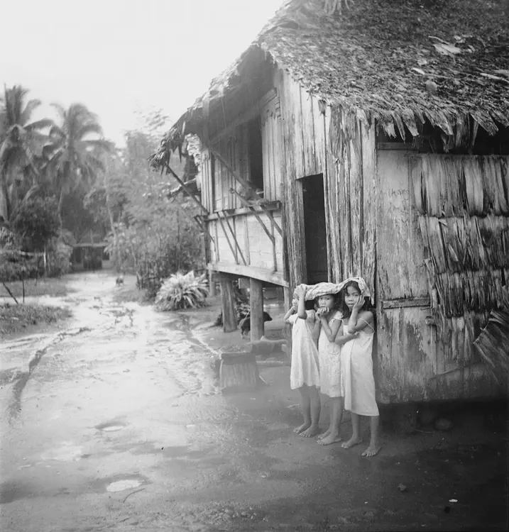 Girls under blanket during rain. Irosin, Sorsogon; Daraga, Albay. May 13, 14 '34. Similar [Raining in Lamboon] 3.8 1/25. Panatomic 6 x 6.
