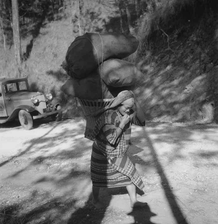 Igorot carrying charcoal along Santa Tomas road & Mt. Data Roads, Baguio, Mt. Province. Feb. 1 1935.