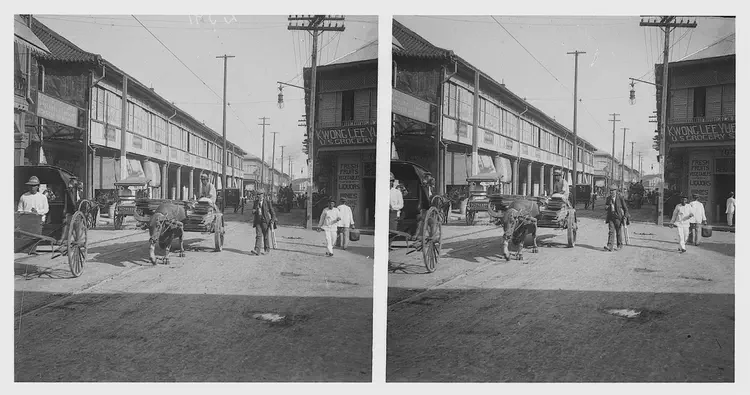 World travel. Manila. Street scene with oxcarts. Note: Cheesetorian looked up the store in the picture at old directories, and the address for Kwong Lee Yuen, US Grocery is 353-355 Echague St. (now C. Palanca St.) in Quiapo.