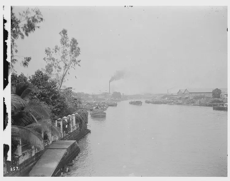 You can see how many of the residence of Manila used to use the river: as a highway. The ramps were used for river boats that dropped of residents off in this case a relatively wealthy river side residence. Billowing smoke at the back showed the industrialization of the city.